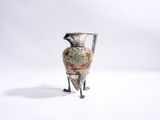 un vase posé sur un support sur une surface blanche