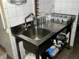 a kitchen with a sink and a counter in it