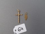 a small gold cross and a small gold leaf on a tag