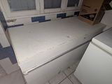 an image of a kitchen with a white refrigerator and a window