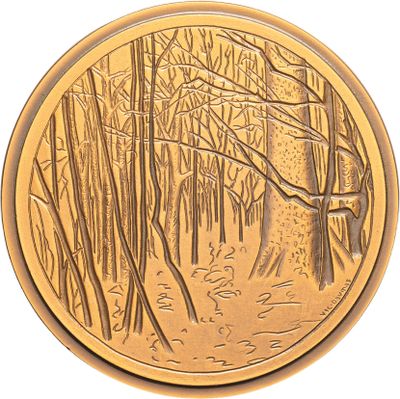an image of a gold coin with a picture of a forest