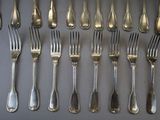 a lot of silver forks and spoons on the table