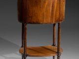 a small round table with a marble top and wooden legs