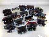 many pairs of sunglasses sitting on a white surface