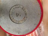 a close up of a red and silver object on a table