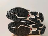 the soles of a pair of black and white shoes on top of a cardboard box