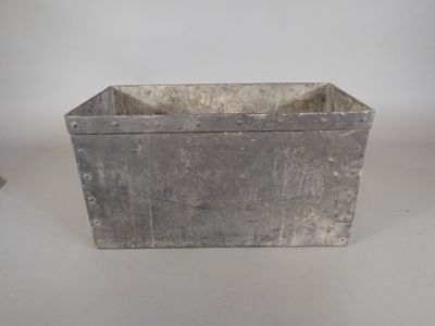 a small metal planter that is sitting on a table