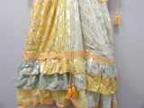 a dress hanging on a wall with a tassel