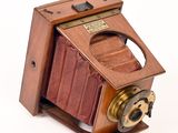 an old camera with a wooden case on it