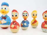 a group of toy figurines of donald and daisy duck