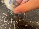 a person that is cleaning a toilet with a brush