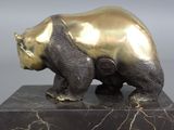 bronze sculpture of a bear on a marble base on a gray background