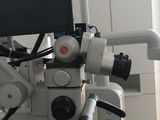 a microscope with a monitor on top of it