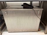 a metal cabinet with a black bag on top of it