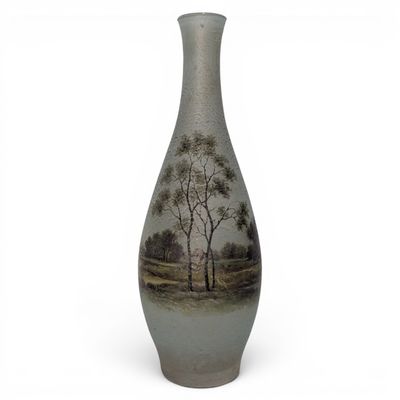 a vase that has a picture of a tree on it