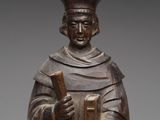 an image of a wooden statue of a man holding a book