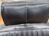 a black leather chair that is sitting in a room