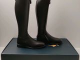 the black boots are sitting on top of a blue box