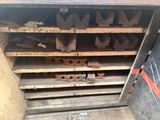 a metal cabinet that has a bunch of wood in it