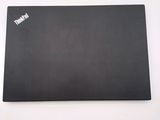 the back of a black laptop computer sitting on top of a white table
