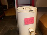 a white trash can sitting on the floor next to a cardboard box