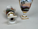 two vases sitting next to each other on a table