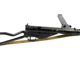 the machine gun is sitting on top of a wooden stand