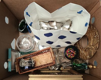 a box full of silverware and other items in it