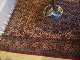 a table with a lamp on top of it on a carpet