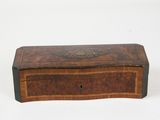an antique wooden box with a decorative design on the lid