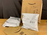 two bags of food sitting on a table next to a cardboard box