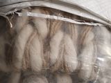 many balls of wool in a plastic bag on a table