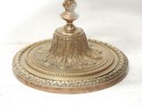 a silver plate with a candle on top of it