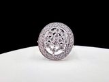 a close up of a diamond ring sitting on top of a white plate