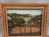 an oil painting of a farm scene in a gold frame on a table