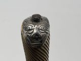 a close up of a metal object with a face on it