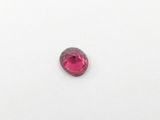 a close up of a pink stone on a white surface