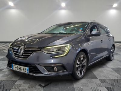 a grey car is parked on a checkered floor in a garage