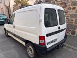 a small white van parked on the side of the street