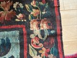 a cat that is sitting on a rug on the floor