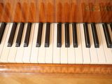 a piano that is sitting on a wooden floor