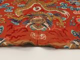 an image of a close up of a red cloth with a dragon on it