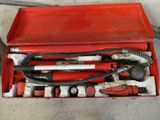 a red tool box with tools in it on the floor