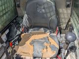 a seat in the back of a vehicle with a broken seat