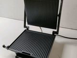a close up of an electric grill on a counter top