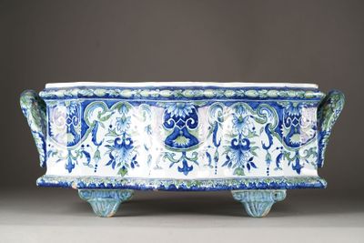an image of a blue and white planter with a design on it