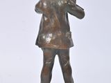 bronze statue of a boy with a bird on his shoulder