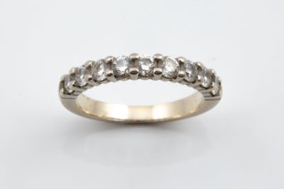 a close up of a diamond ring on a white background
