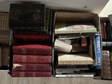 a lot of books that are stacked on top of each other