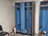 two blue lockers in the corner of a room